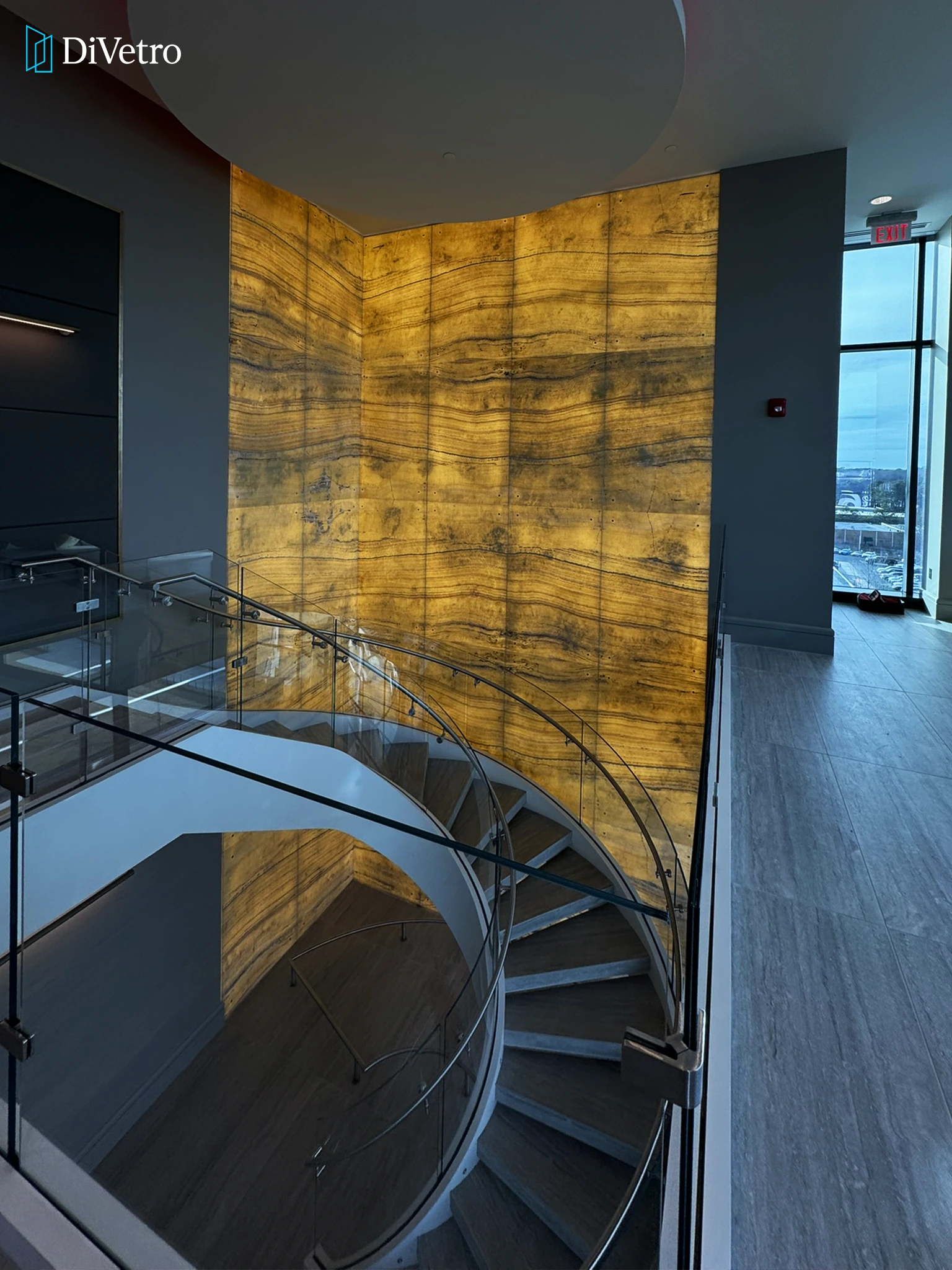 Real project — luminous backlit onyx panels with glass staircase